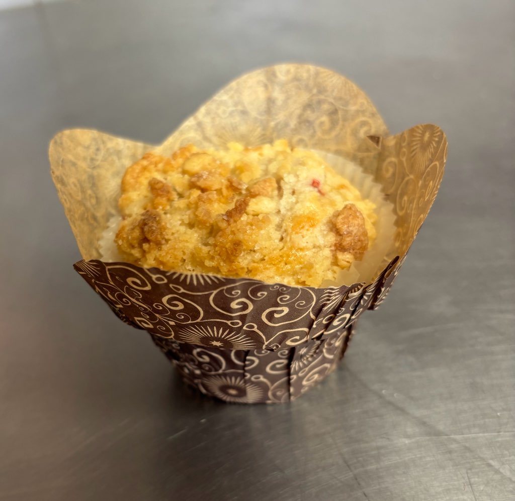 Crumb-topped muffin in a decorative wrapper