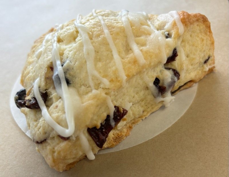 Cranberry scone with white icing drizzle