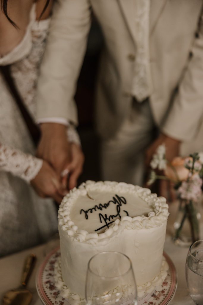 Couple cutting a wedding cake from Mountain Berry Bakery